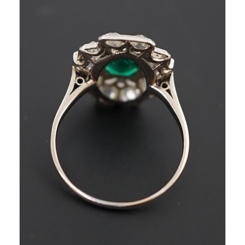 604 - An early to mid 20th century white gold?, emerald and diamond cluster set stepped oval dress ring, w... 