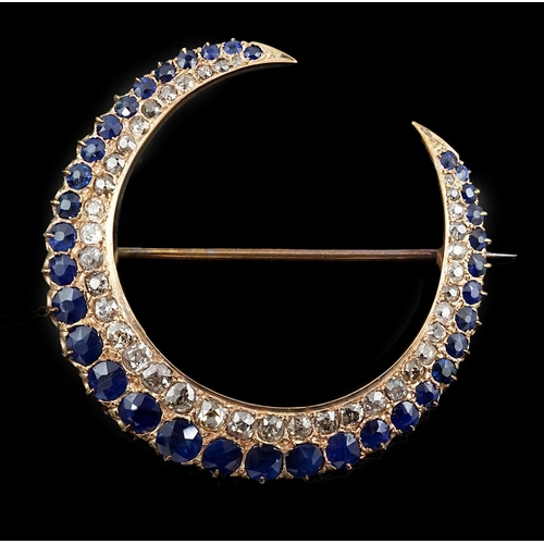 605 - An early to mid 20th century gold, graduated sapphire and graduated diamond set two row crescent bro... 