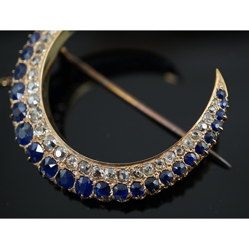 605 - An early to mid 20th century gold, graduated sapphire and graduated diamond set two row crescent bro... 