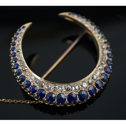 605 - An early to mid 20th century gold, graduated sapphire and graduated diamond set two row crescent bro... 