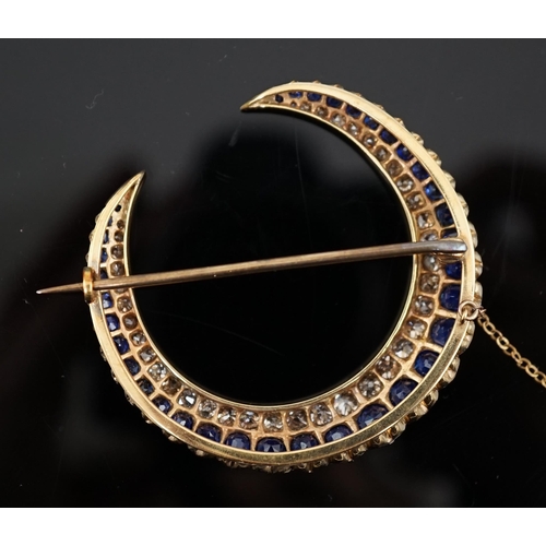 605 - An early to mid 20th century gold, graduated sapphire and graduated diamond set two row crescent bro... 