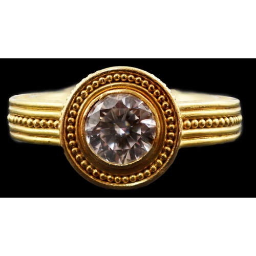 607 - A 22k gold and collet set solitaire diamond dress ring, the setting and shank with beaded decoration... 