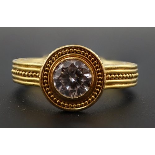 607 - A 22k gold and collet set solitaire diamond dress ring, the setting and shank with beaded decoration... 