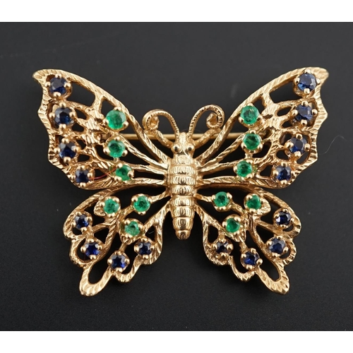 608 - A modern pierced 14ct gold, emerald and sapphire cluster set butterfly brooch, width 38mm, gross wei... 