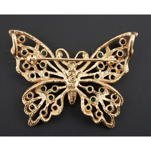 608 - A modern pierced 14ct gold, emerald and sapphire cluster set butterfly brooch, width 38mm, gross wei... 