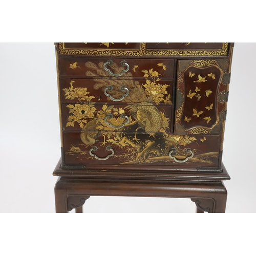 67 - A Japanese Meiji period lacquered table cabinet, Meiji period, decorated with cockerels, peacocks, f... 