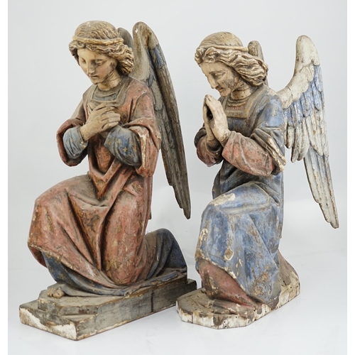 7 - A pair of late 19th century polychrome carved painted pine praying archangels, each kneeling upon a ... 