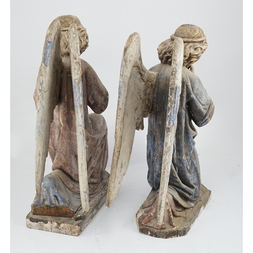 7 - A pair of late 19th century polychrome carved painted pine praying archangels, each kneeling upon a ... 