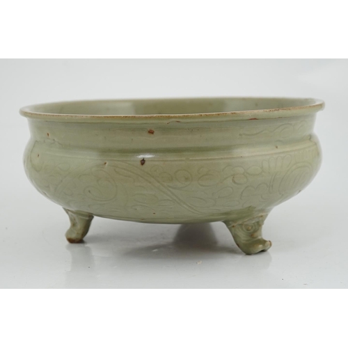 70 - A Chinese Ming Longquan celadon tripod censer, 14th/15th century, the exterior incised with scrollin... 