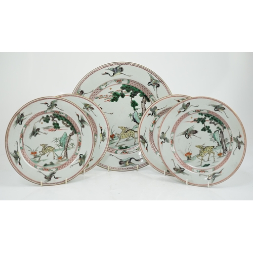 71 - A Chinese famille verte deer and crane dish and four matching plates, Kangxi period, each painted ... 