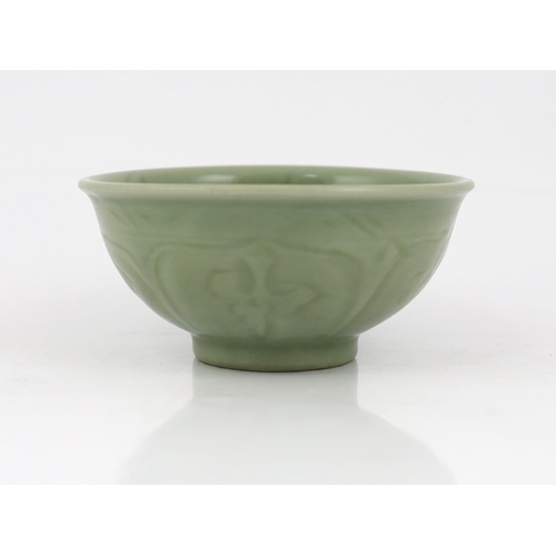 78 - A Chinese Longquan celadon bowl, Yuan Dynasty, the interior carved with lotus flowers and the exteri... 