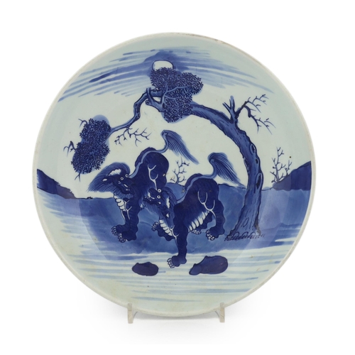 81 - A large Chinese blue and white mythical beasts saucer dish, Yongzheng period, the centre painted w... 