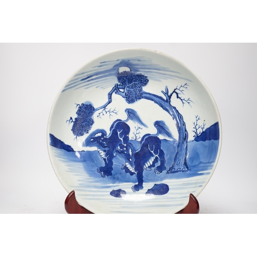81 - A large Chinese blue and white mythical beasts saucer dish, Yongzheng period, the centre painted w... 