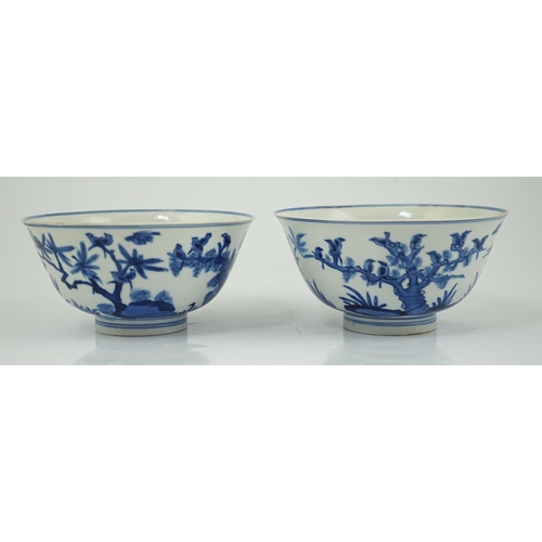 84 - A near pair of Chinese blue and white birds bowls, Kangxi period, each painted with birds amid tre... 