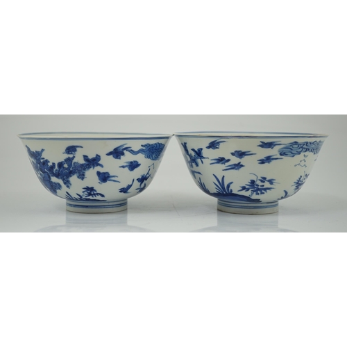 84 - A near pair of Chinese blue and white birds bowls, Kangxi period, each painted with birds amid tre... 