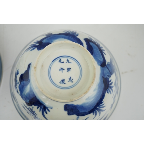 84 - A near pair of Chinese blue and white birds bowls, Kangxi period, each painted with birds amid tre... 