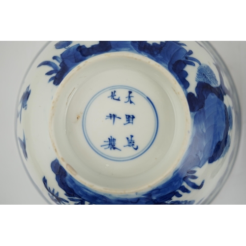 84 - A near pair of Chinese blue and white birds bowls, Kangxi period, each painted with birds amid tre... 