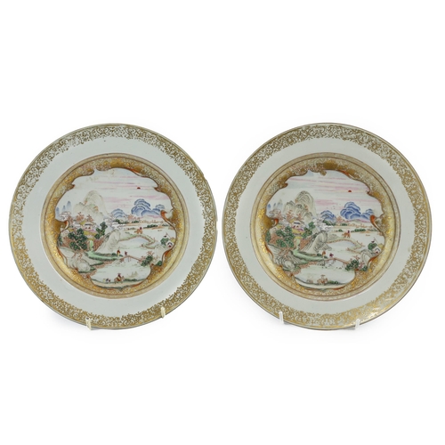 87 - A pair of Chinese famille rose landscape plates, Yongzheng-Qianlong period, each finely painted wi... 
