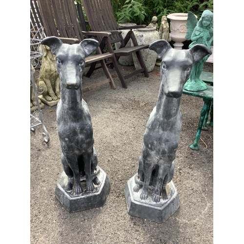 1004 - A pair of cast iron faux lead sitting hound garden ornaments, height 92cm. Condition - good