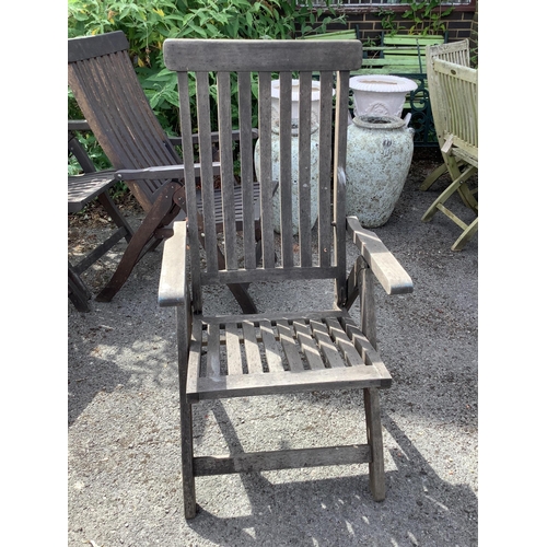 1014 - A set of four stained teak folding garden armchairs. Condition - fair