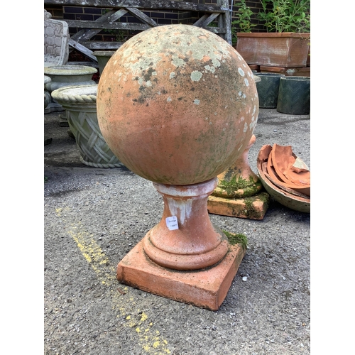 1024 - A large pair of weathered terracotta sphere garden ornaments, one in need of restoration, height 58c... 