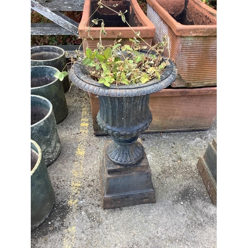 1034 - A pair of Victorian style circular black painted cast iron campana urns on stands, diameter 38cm, he... 