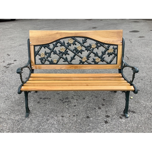 1050 - A Victorian style cast metal and slatted wood garden bench, width 130cm, height 90cm.  Condition - g... 