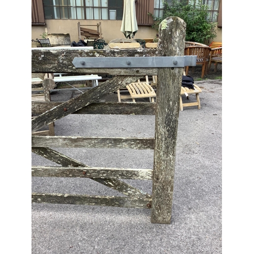 1052 - A pair of 12ft Biddenden hardwood gates with galvanised mounts. Condition - poor to fair