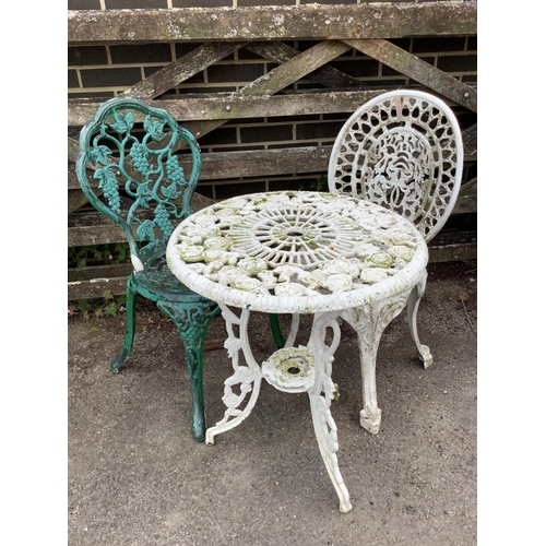1053 - A Victorian style painted aluminium circular garden table, diameter 56cm, height 65cm, and two chair... 