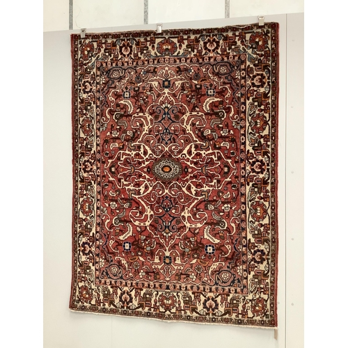 1059 - A North West Persian brick red ground rug, 200 x 148cm. Condition - fair