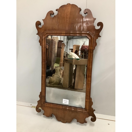 1067 - A walnut fret cut wall mirror, width 41cm, height 75cm. Condition - good