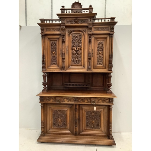 1069 - A late 19th century Continental carved walnut buffet, width 150cm, depth 58cm, height 270cm.  Condit... 