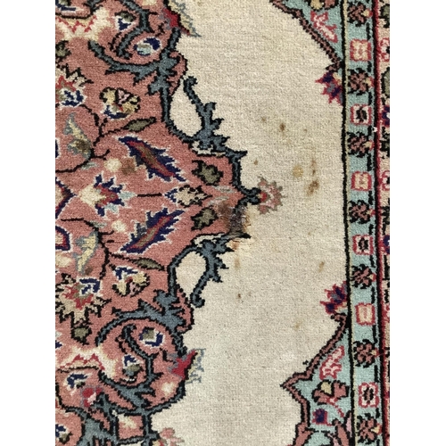 1074 - A Turkish ivory ground rug and a similar smaller red ground rug, larger 194 x 141cm. Condition - fai... 