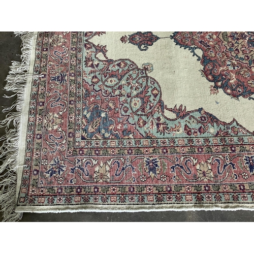 1074 - A Turkish ivory ground rug and a similar smaller red ground rug, larger 194 x 141cm. Condition - fai... 