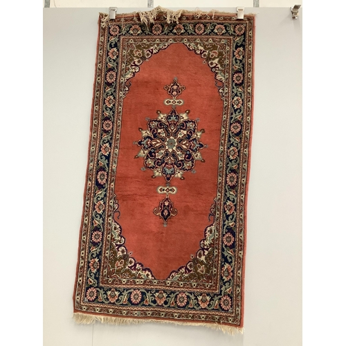 1074 - A Turkish ivory ground rug and a similar smaller red ground rug, larger 194 x 141cm. Condition - fai... 