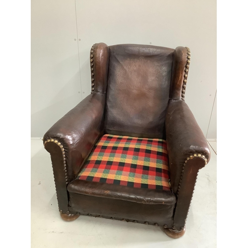 1102 - An early 20th century studded tan leather club armchair, width 84cm, depth 90cm, height 92cm. Condit... 