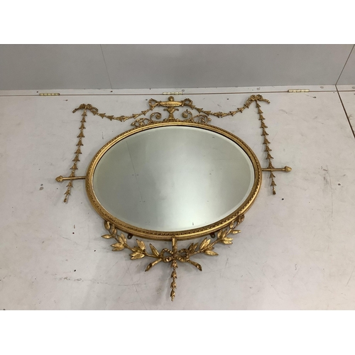 1115 - An Edwardian Sheraton style oval giltwood and composition wall mirror, width 105cm, height 106cm. Co... 