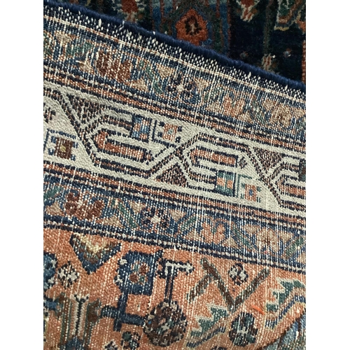 1123 - A North West Persian blue ground rug, 194 x 130cm. Condition - fair