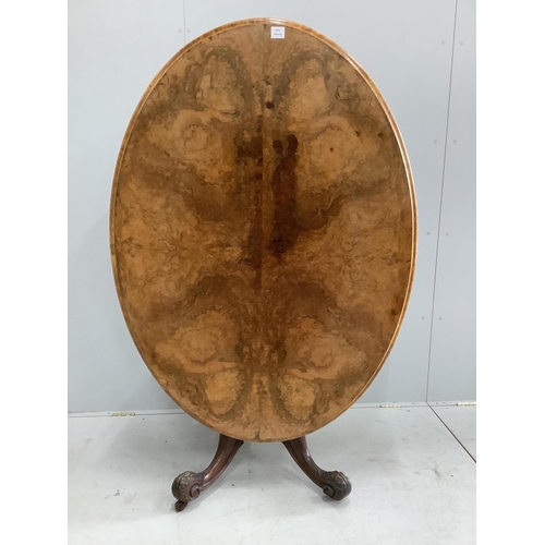 1127 - A Victorian figured walnut oval tilt top loo table, width 142cm, depth 104cm, height 72cm, together ... 