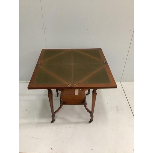 1147 - A late Victorian walnut envelope card table, width 56cm, height 74cm. Condition - fair