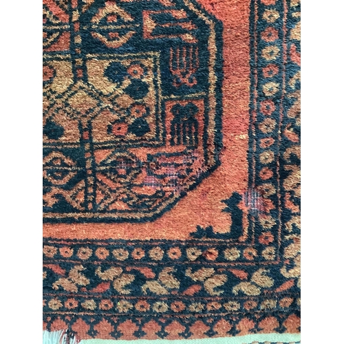1186 - A pair of Afghan red ground rugs, each 144 x 75cm. Condition - fair
