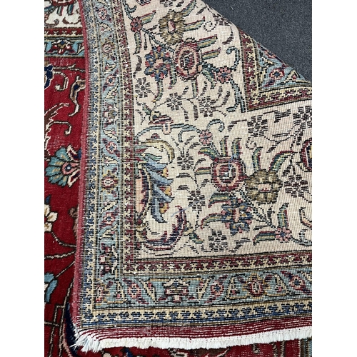 1212 - A Persian red ground carpet, worn, 340 x 340cm. Condition - fair