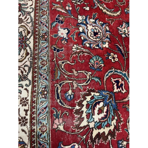 1212 - A Persian red ground carpet, worn, 340 x 340cm. Condition - fair