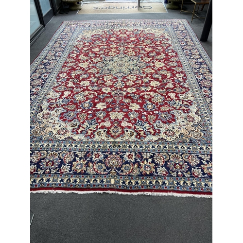 1215 - A Persian burgundy ground carpet, 410 x 282cm. Condition - good