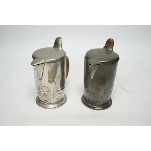 1254 - Archibald Knox (1864-1933) for Liberty & Co, two Tudric hot water jugs and an Art Nouveau brass pen ... 
