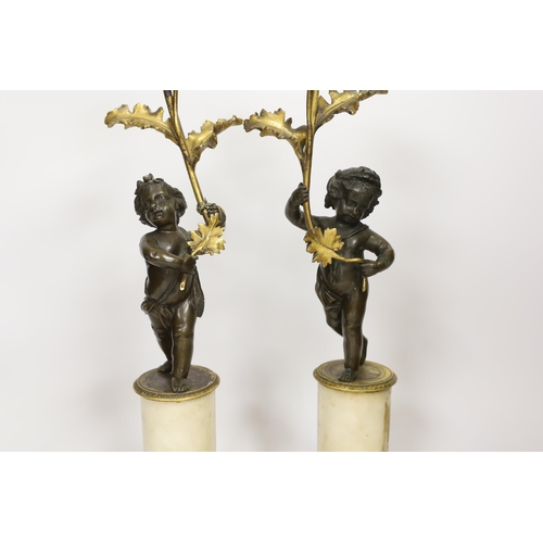1266 - A pair of Regency bronze and ormolu amorini candlesticks, with white marble plinths, 40cm. Condition... 