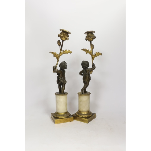 1266 - A pair of Regency bronze and ormolu amorini candlesticks, with white marble plinths, 40cm. Condition... 