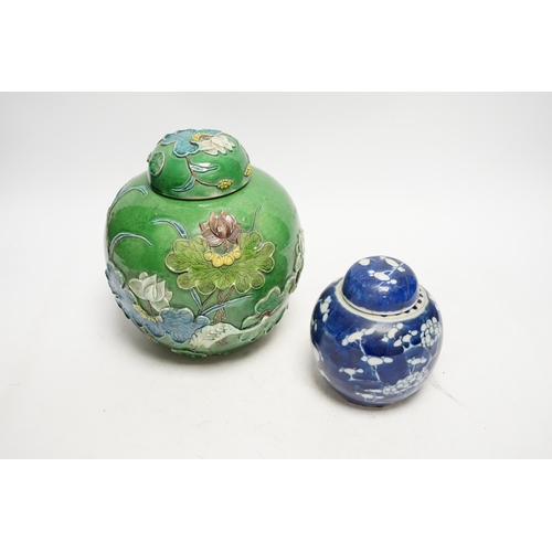 1267 - Two Chinese lidded ginger jars, one with applied decoration and the other with blue and white prunus... 