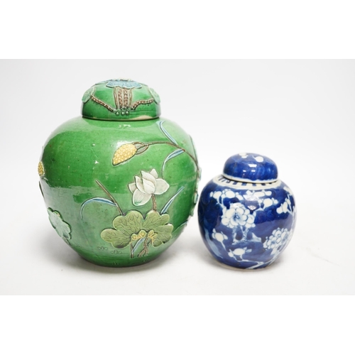 1267 - Two Chinese lidded ginger jars, one with applied decoration and the other with blue and white prunus... 