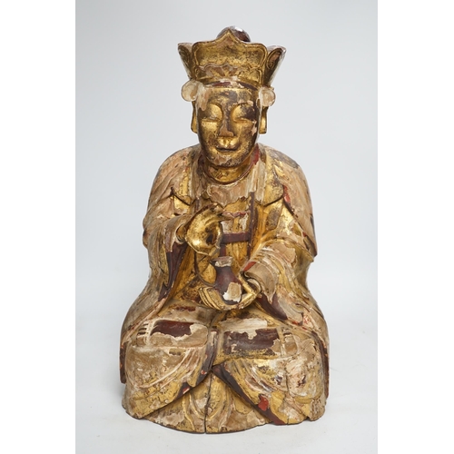 1282 - A Chinese gilt lacquered wooden figure of Buddha, possibly Yuan to Ming, 42cm high. Condition - poor... 